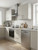 odern kitchen layout featuring Layed Matte Silk Oat Vinyl Wrap on cabinets alongside a stainless steel oven and dishwasher.
