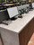 A commercial retail checkout counter and power tool display flawlessly upgraded with the durable, industrial look of Layed Stone Cement Vinyl Wrap.