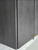 A macro view of a kitchen cabinet corner highlighting the flawless, seamless edge fold achievable with Layed Grey Cement Vinyl Wrap.