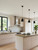 A large kitchen island wrapped in a stunning natural wood effect architectural film for a Scandinavian modern look.