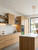 A bright, contemporary kitchen space upgraded with a realistic wood effect vinyl wrap on all cabinetry.