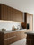 A realistic finish of an oak wood effect vinyl wrapping kit applied to modern kitchen cabinets.