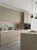 A full kitchen makeover showcasing cabinets upgraded with a painted wood effect wrapping kit.