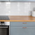 A close-up view showing the realistic wood grain texture of a painted wood kitchen vinyl wrap.