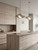 A modern kitchen makeover featuring cabinets wrapped in a realistic, travertine effect vinyl.