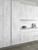 Close-up of flat-panel kitchen cabinets cleanly wrapped in a light grey concrete architectural film.