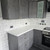 A modern kitchen makeover featuring cabinets wrapped in a concrete effect vinyl.