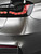 Rear quarter panel and LED taillight of a sedan wrapped in high gloss Super Gloss Metallic Liquid Silver vinyl wrap SGM-LS51