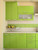 Upper and lower kitchen cabinets transformed with Layed Matte Textured Apple Green Vinyl Wrap, featuring sleek handles and complementing a matching green tile backsplash.
