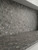 Close-up of a seamless kitchen countertop and backsplash wrapped in Layed Grigio Marble Vinyl Wrap, highlighting its realistic dark grey stone base and crushed terrazzo-style flecks.