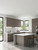A bright, modern kitchen featuring handleless base cabinets, wall cabinets, and a center island completely transformed using Layed Matte Silk Brown Grey Vinyl Wrap, paired with white speckled countertops.