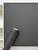 A roll of Layed Matte Silk Fossil Grey vinyl applied to a flat panel, highlighting its flawless, opaque matte texture against a white border.