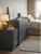 A cozy, modern bedroom featuring a sleek dresser and matching nightstand elegantly upgraded using Layed Matte Silk Fossil Grey Vinyl Wrap.