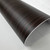 A roll of Layed Macassar Ebony Wood Vinyl Wrap MEW96, showcasing its luxurious dark brown and black striped wood grain texture.
