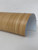 A close-up view of Layed Natural Pine Wood Vinyl Wrap unrolled on a white surface, displaying the bright, natural pine timber tones and subtle wood knots.