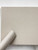 A piece of Layed Beige Linen Fabric Vinyl Wrap partially unrolled, showcasing the highly realistic woven textile pattern and premium matte finish.
