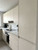 A bright, modern kitchen showcasing flat-panel upper and lower cabinets seamlessly upgraded with the warm, woven look of Layed Beige Linen Fabric Vinyl Wrap.