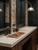 A vintage-inspired barbershop grooming station featuring an exposed brick wall and a highly durable countertop transformed with Layed Travertine Stone Vinyl Wrap.