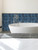 Marine blue rectangular self adhesive wall tiles used on a contemporary bathroom wall