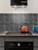 Contemporary bathroom design with black peel and stick rectangle wall tiles and minimalist basin