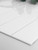 Close up of Ghost White peel and stick composite tiles showing thickness and edge detail