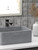 Modern bathroom interior featuring a concrete vessel sink against a grey slate-textured peel and stick tile accent wall