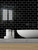 Black subway peel and stick tiles creating a bold feature wall in a modern interior