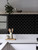 Black subway peel and stick tiles by Layed installed on a modern kitchen splashback