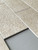 Close up of stone concrete peel and stick subway tiles showing textured beige stone effect finish