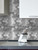 Contemporary geometric wall cladding using silver aluminium hexagon tiles in a modern kitchen setting.
