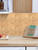 Modern kitchen backsplash renovated with moisture-resistant PWCT62 pine wood chevron peel and stick tiles.