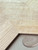 Close-up view of the realistic wood grain and texture on Sonoma Oak chevron composite wall tiles.