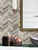 Modern living room featuring a DIY accent wall installed with Layed rustic wood chevron peel and stick panels.