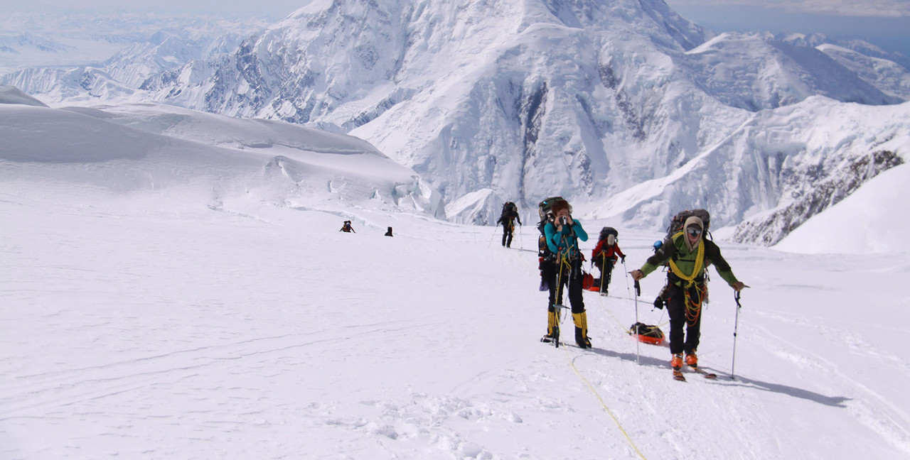 People Walking Up Ski Mountain