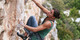 A pStyles user climbing a vertical rock wall