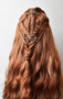 The lace front braided wig in light brown with barrettes and beads.