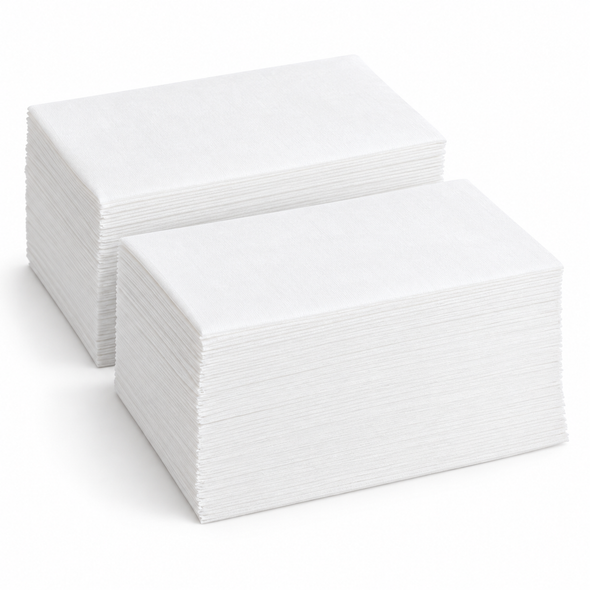 Two stacks of Solex white linen-like disposable guest towels