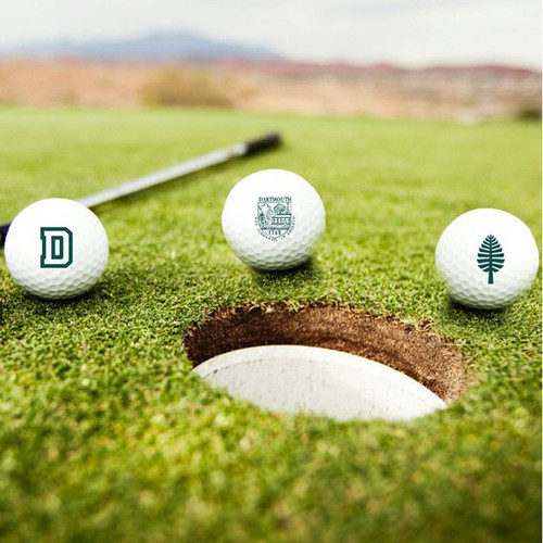 White golf balls with 'D,' lone pine, and Dartmouth Shield in green