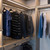 Closet interior with integrated ClickBright Selectable LED lighting above hanging clothes, providing bright and even illumination for wardrobe organization Closet interior with integrated ClickBright Selectable LED lighting above hanging clothes, providing bright and even illumination for wardrobe organization