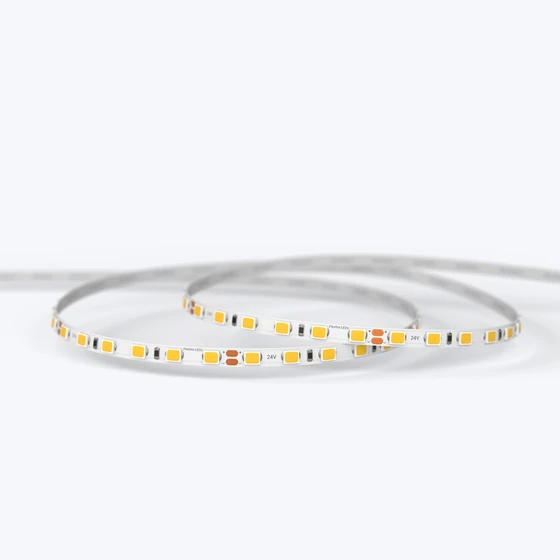 A coiled UltraBright™ Slim IP20 LED Strip showing the high-density circuit board and 3M adhesive backing.