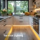 Bright under-cabinet Accent LED strip lighting illuminating a modern kitchen backsplash, toekick, and countertop