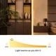 UltraBright™ Sienna Dim-to-Warm IP20 LED Strip warming from 3000K to 1800K as it dims beside a headboard.