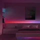 ColorBright™ RGB Digital Pixel IP20 LED Strip creating purple and red color effects behind a modern platform bed.