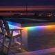 Rooftop patio bar counter with rainbow gradient light from the Outdoor ColorBright™ RGB Digital Pixel IP65 LED Strip.