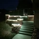 ColorBright™ RGB + Dynamic Tunable White IP65 LED Strip Light highlighting stone retaining walls and steps in a backyard.