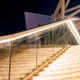 Bright Valor™ Diffused IP67 LED Strip seamlessly outlining outdoor stone stairs and a glass safety railing at night.