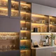 UltraBright™ Slim IP20 LED Strips providing accent lighting inside modern dark grey kitchen shelving and glass cabinets.