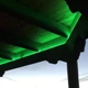 Outdoor wooden gazebo ceiling beams lit in green with the Outdoor ColorBright™ RGB 150 IP65 LED Strip.