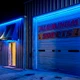 Commercial aluminum-sheet-store garage building exterior backlit in blue with the Outdoor ColorBright™ RGB 150 IP65 LED Strip.