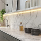 Outdoor Vital™ 100 White IP65 LED Strip light providing under-shelf illumination over a marble kitchen backsplash.